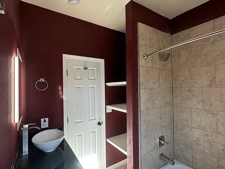 It has lots of deep storage shelves with shower tub.