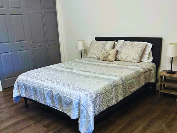 Comfortable bedroom with queen bed, nightstands, and large closet. Lakeland, FL