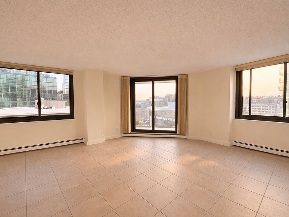 Sun-filled living room with a calm, welcoming feel and direct access to the private balcony. The generous scale and natural light create a comfortable space to relax, entertain, and make the room your own.