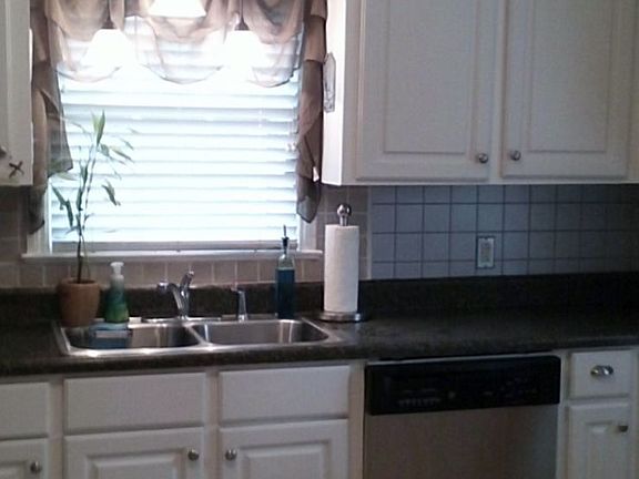 Updated Lighting, New cabinet fronts, chrome knobs, pantry closet, tile floor