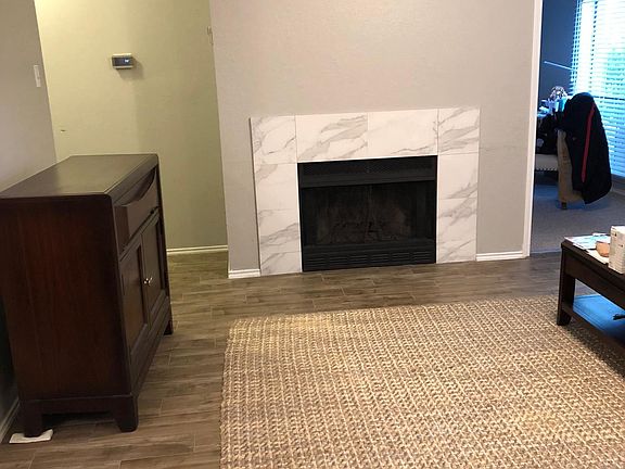 Living Room with beautiful fire place and open high vaulted ceilings.
