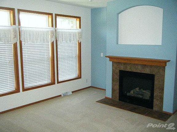 This home has large windows and fireplace!
