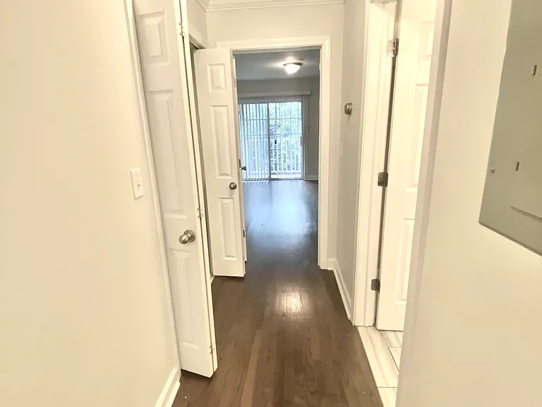 Hall to first floor primary bedroom with private balcony