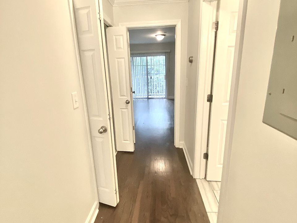 Hall to first floor primary bedroom with private balcony