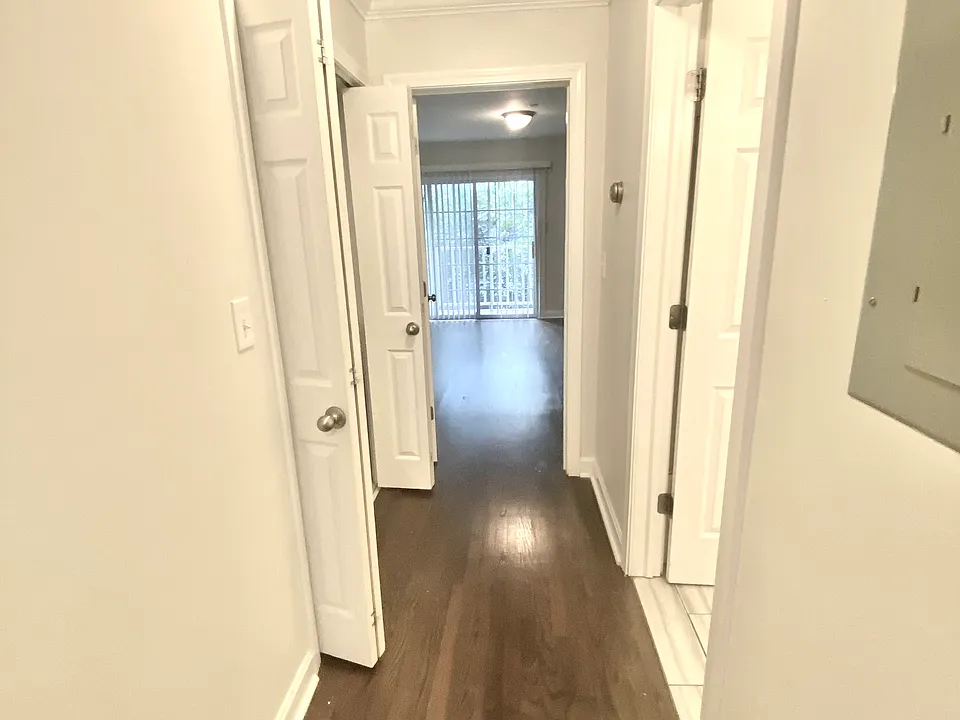 Hall to first floor primary bedroom with private balcony