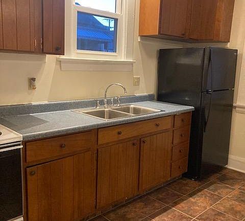kitchen with track lighting and new refrigerator
