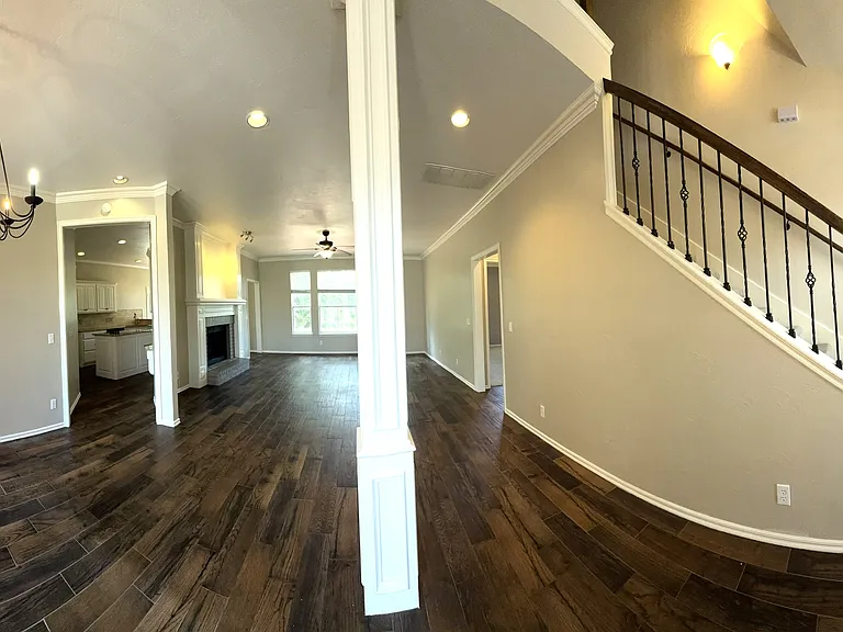 Panoramic of the dinning room, living room and front entry. New brighter paint to update the color.