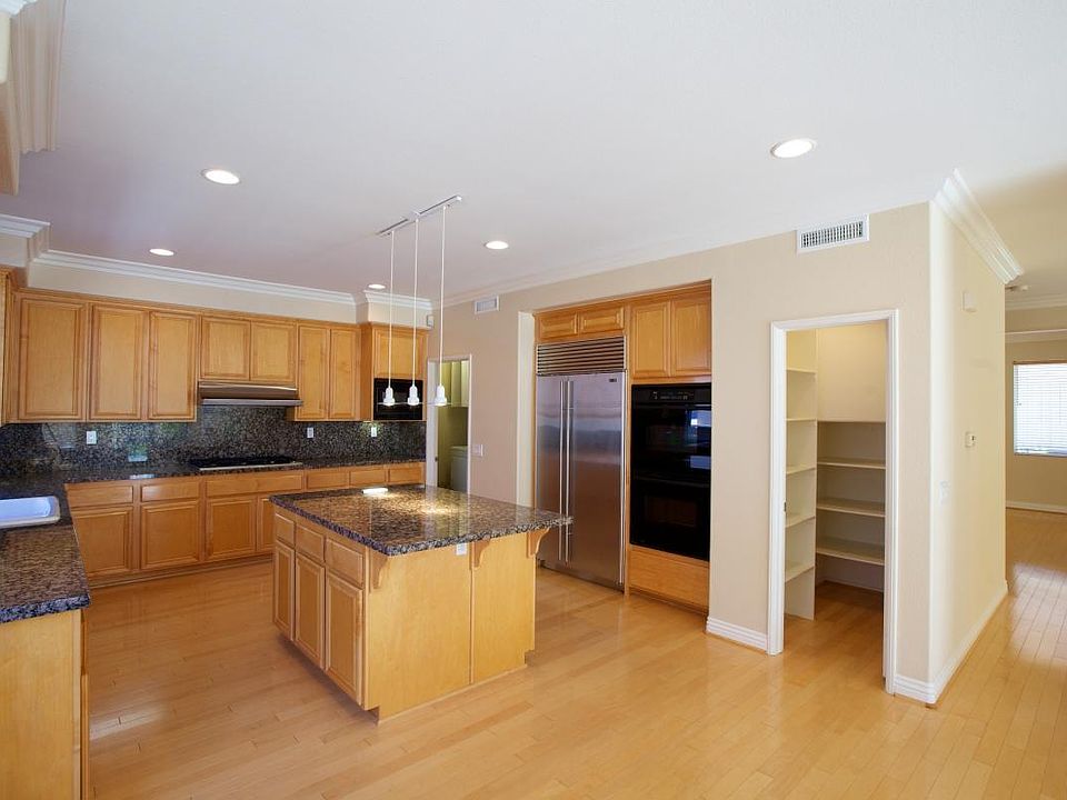 Gourmet kitchen with stainless steel appliances including su