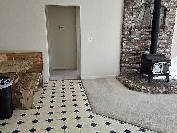 From Kitchen to dining nook and hallway to 2 bedrooms, woodburning stove