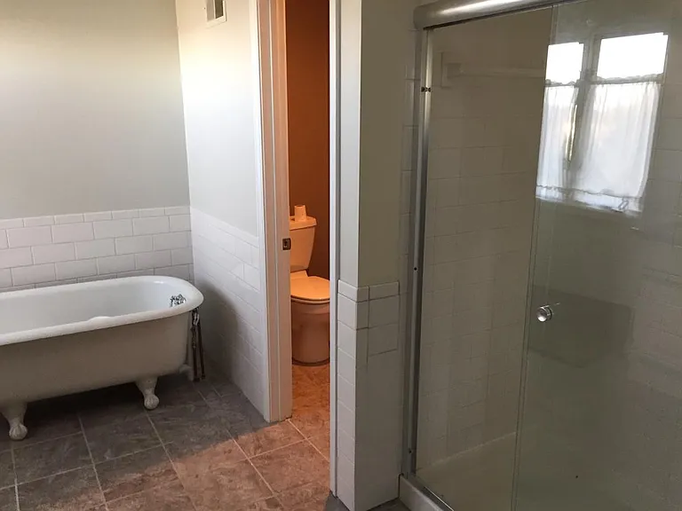 Enclosed toilet area/ antique clawfoot soaker / shower