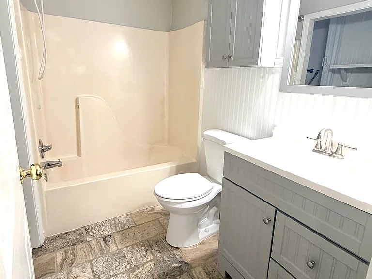 Full Bathroom downstairs next to family room, kitchen, and two bedrooms