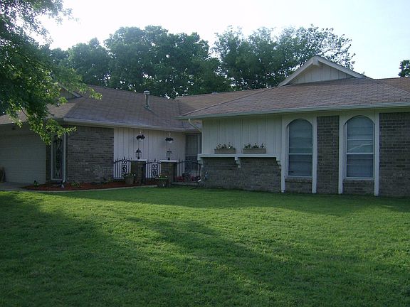 Alternate view of front yard, has mature trees, gutters