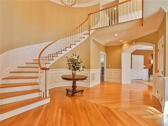Grand foyer with circular staircase and extensive moldings