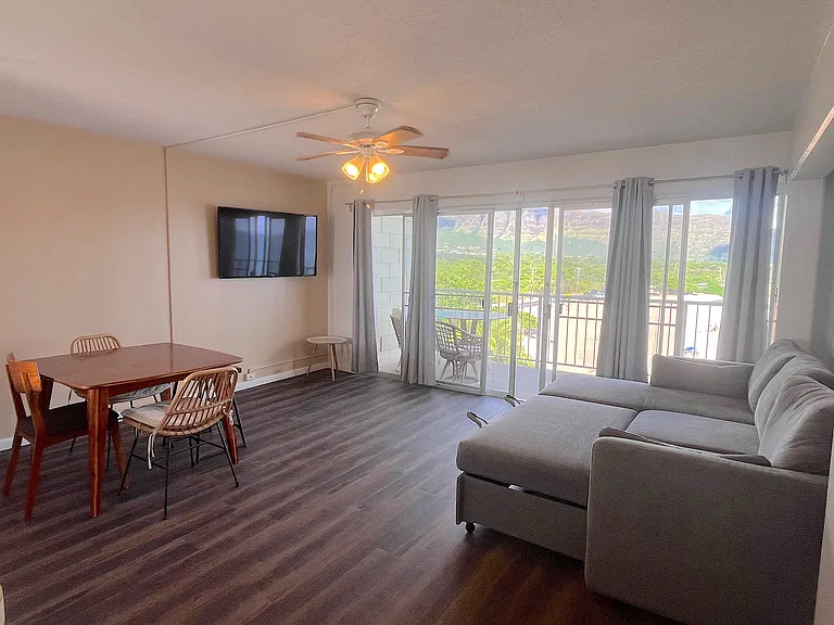 Living room from front door/kitchen area, with sofa bed set-up.