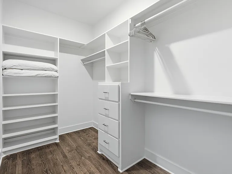 Primary bedroom on the 3rd floor with a king bed, Smart TV, ensuite bath, and room darkening shades. Includes a large walk-in closet. Tastefully decorated with high-end modern furnishings.