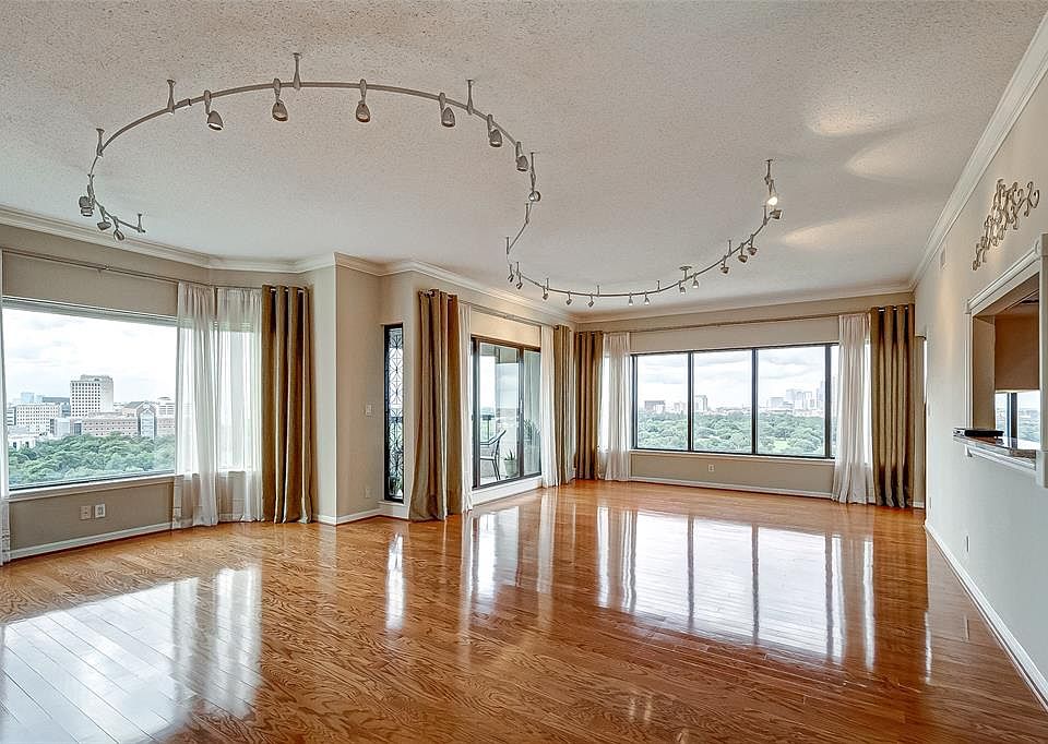 Spacious living room and dining room with beautiful wood floors and a spectacular view.