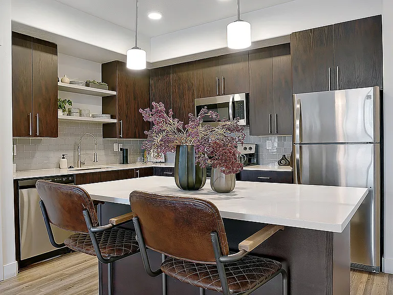 Large kitchen island with seating and modern pendant lighting.