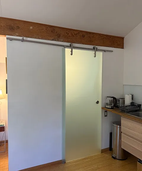 Opaque sliding glass door to Bathroom