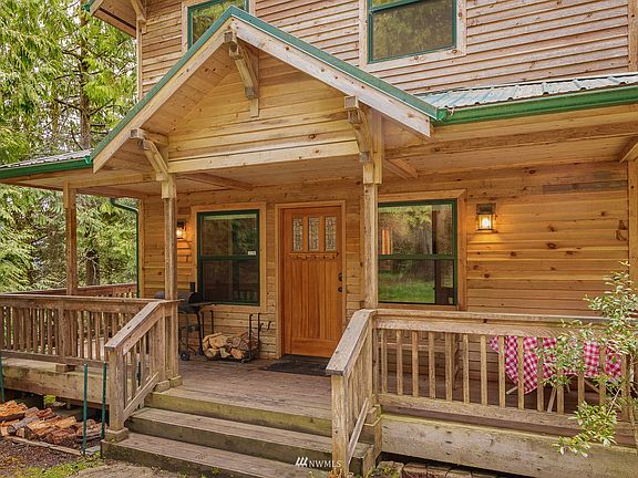 Double paned windows frames matching the metal roof,  solid & beautiful front door welcomes you inside.
