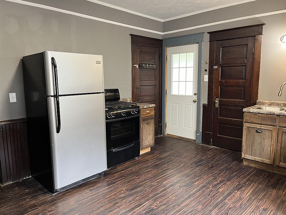 Large kitchen, showing the back door (white) which is entered from the driveway.