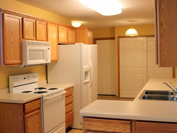 Kitchen with pantry. 1/2 bath, storage, and garage access.