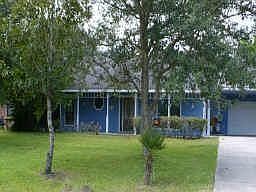 This 3/2/2 home with a seperate guest quarters sits on over 3 acres with a pond and many trees.