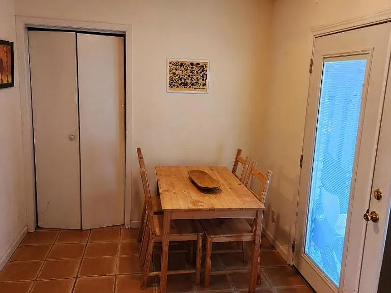 Dining area with french doors to back yard, closet to the left is washer/drier unit.