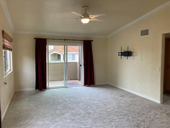 Living Room with vaulted ceiling, fan, and brand new carpet