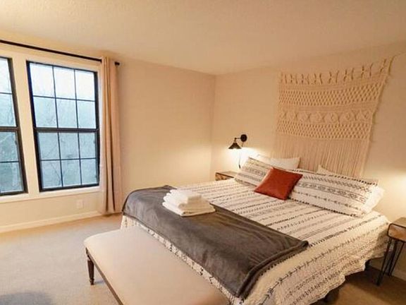 Bedroom 1: King size bed with private bathroom, two nightstands, private closet, room darkening curtains, and dedicated work space