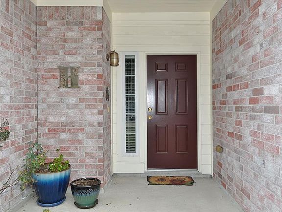 Nice covered brick entry with beautiful wood door welcomes you to this lovely home.