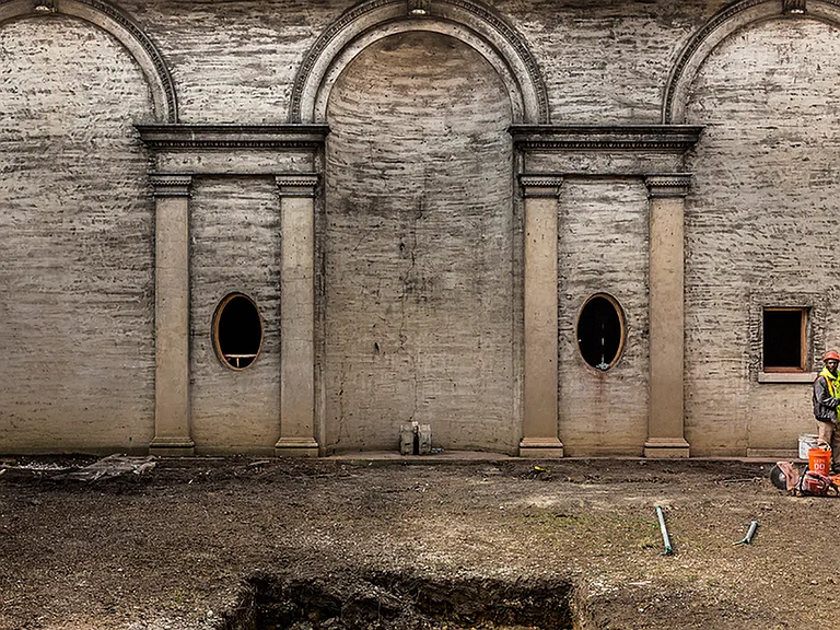 Before: Exterior of building during renovation, showing the inlay of arches