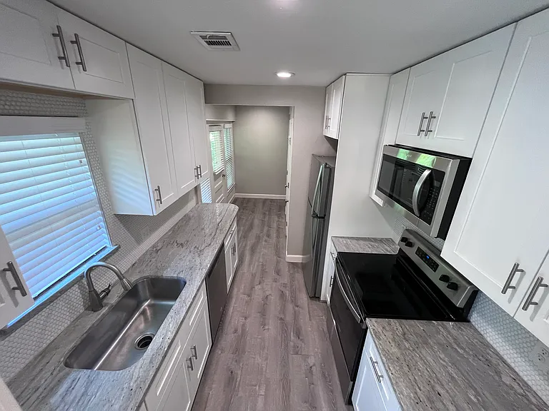 Kitchen with new cabinets, quartz, and stainless steel appliances