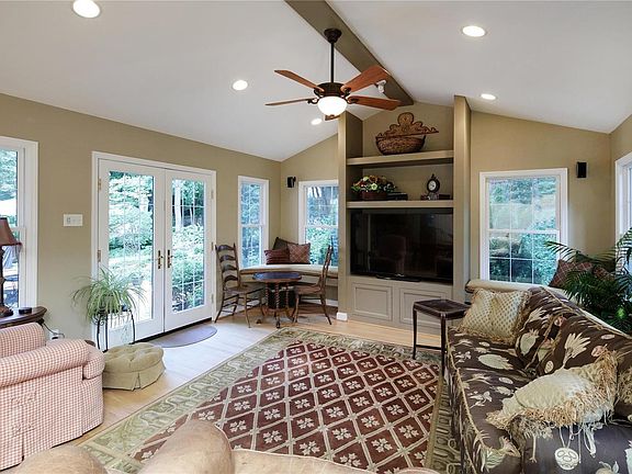 Vaulted ceiling great room addition is open to kitchen, breakfast and hearth rooms.  French doors lead to patio and fenced yard.