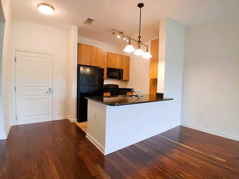 Open Kitchen with Sleek Granite Counters. New Stainless Refrigerator, Stove, and Dishwasher to be Installed in August