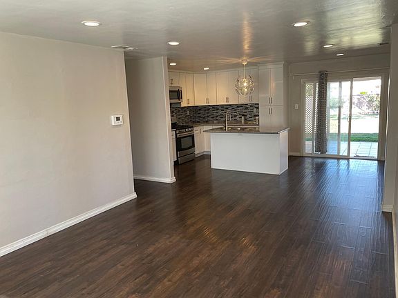 View from entrance. Living room, kitchen and door to backyard.