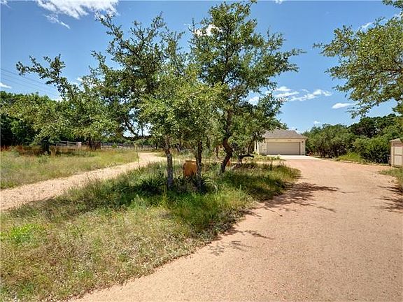 From automatic gate looking towards home. Drought-tolerant landscaping and native Buffalo grass keep