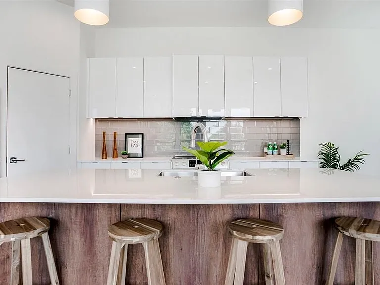 Modern kitchen island featuring a white countertop and wood-finish paneling