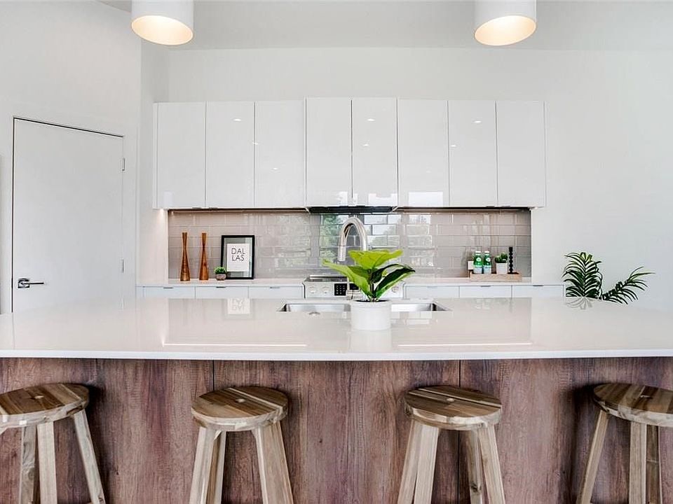 Modern kitchen island featuring a white countertop and wood-finish paneling