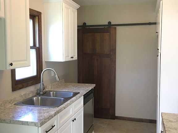 White kitchen with barn door