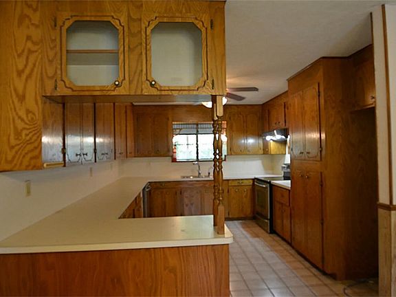 KITCHEN FEATURES TONS OF CUSTOM WOOD CABINETS