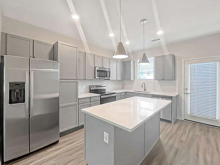 Designer kitchen with a full stainless appliance package.