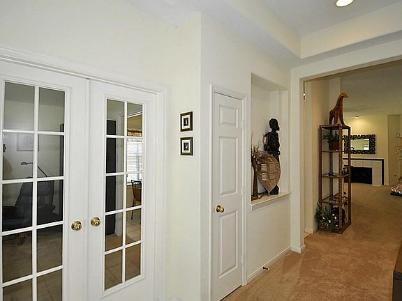 Formal entry with art niche; French doors lead to the study