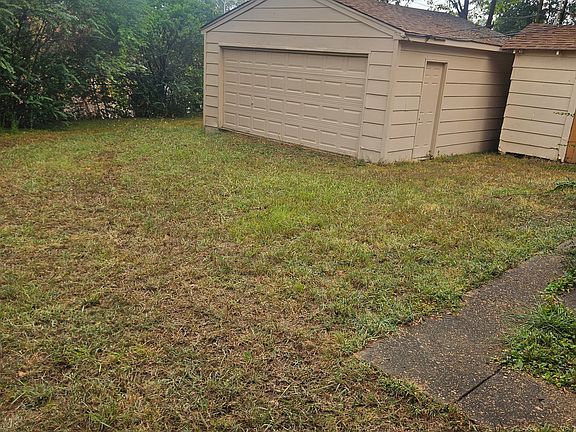 Fenced Back yard with Garage/workshop and shed