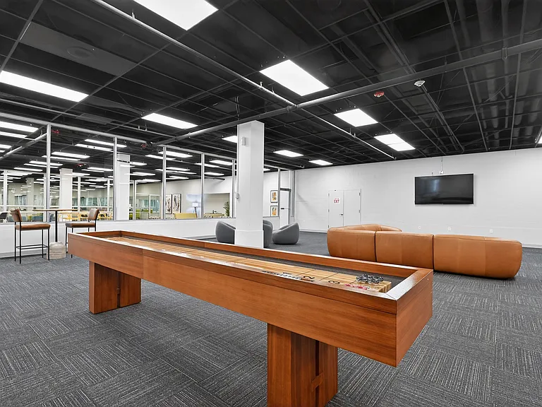 Huge Game Room with Billiard Tables, Shuffle Board and Lounge Seating at University Plaza NIU Apartments