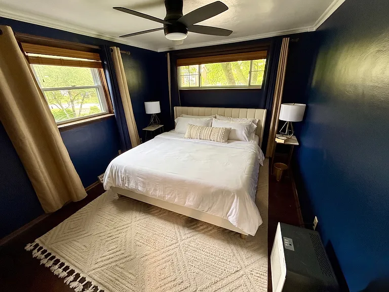 King bedroom with Eight Sleep temperature-controlled smart bed and blackout curtains _ designed for deep sleep, ideal for night-shift medical workers