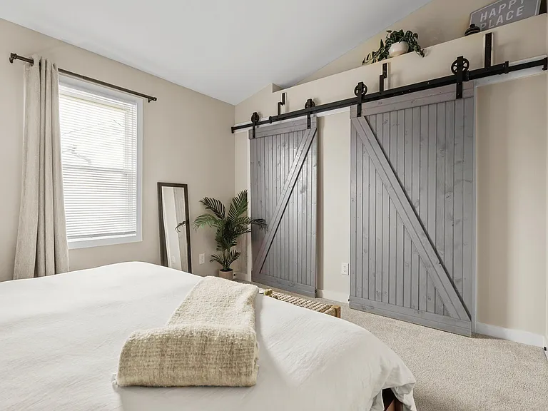 Oversized primary closet with extra storage space and separate entry to full bath.