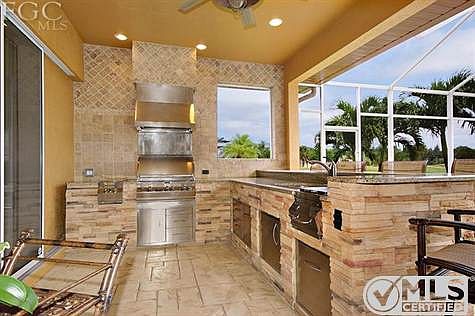 This is a custom built stone and stainless out door kitchen and bar.  Exquisite!