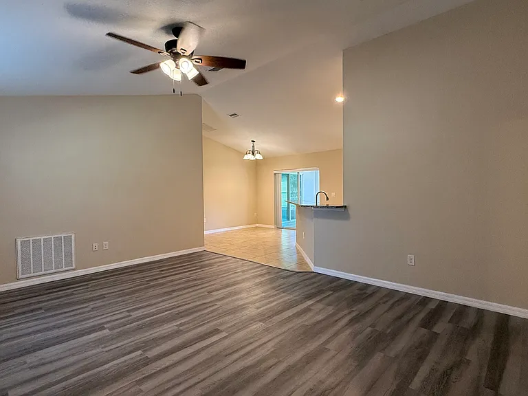 Living room area has new vinyl flooring. This makes cleaning more convenient.