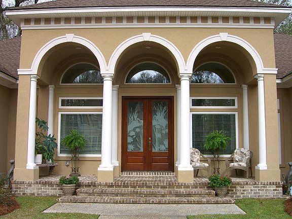 Close-up view of covered front porch with 3 arches