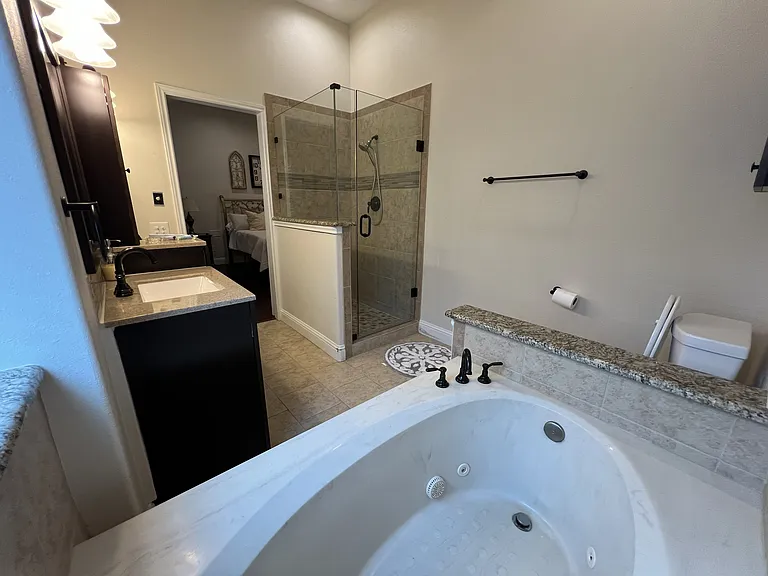 Spacious primary bath layout with oversized soaking tub and separate shower enclosure.